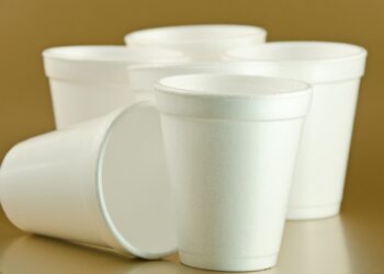 Styrofoam cups on a gold background..